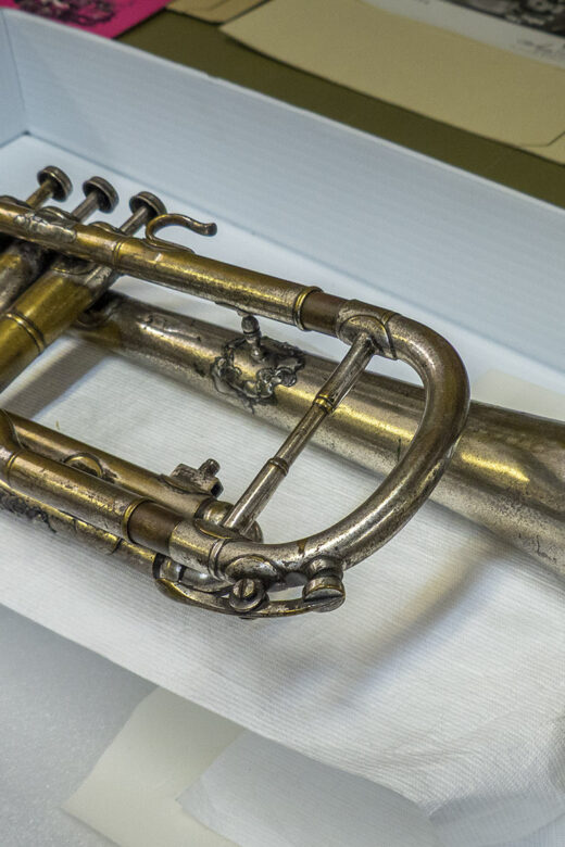 Louis Armstrong's first cornet laying on museum table