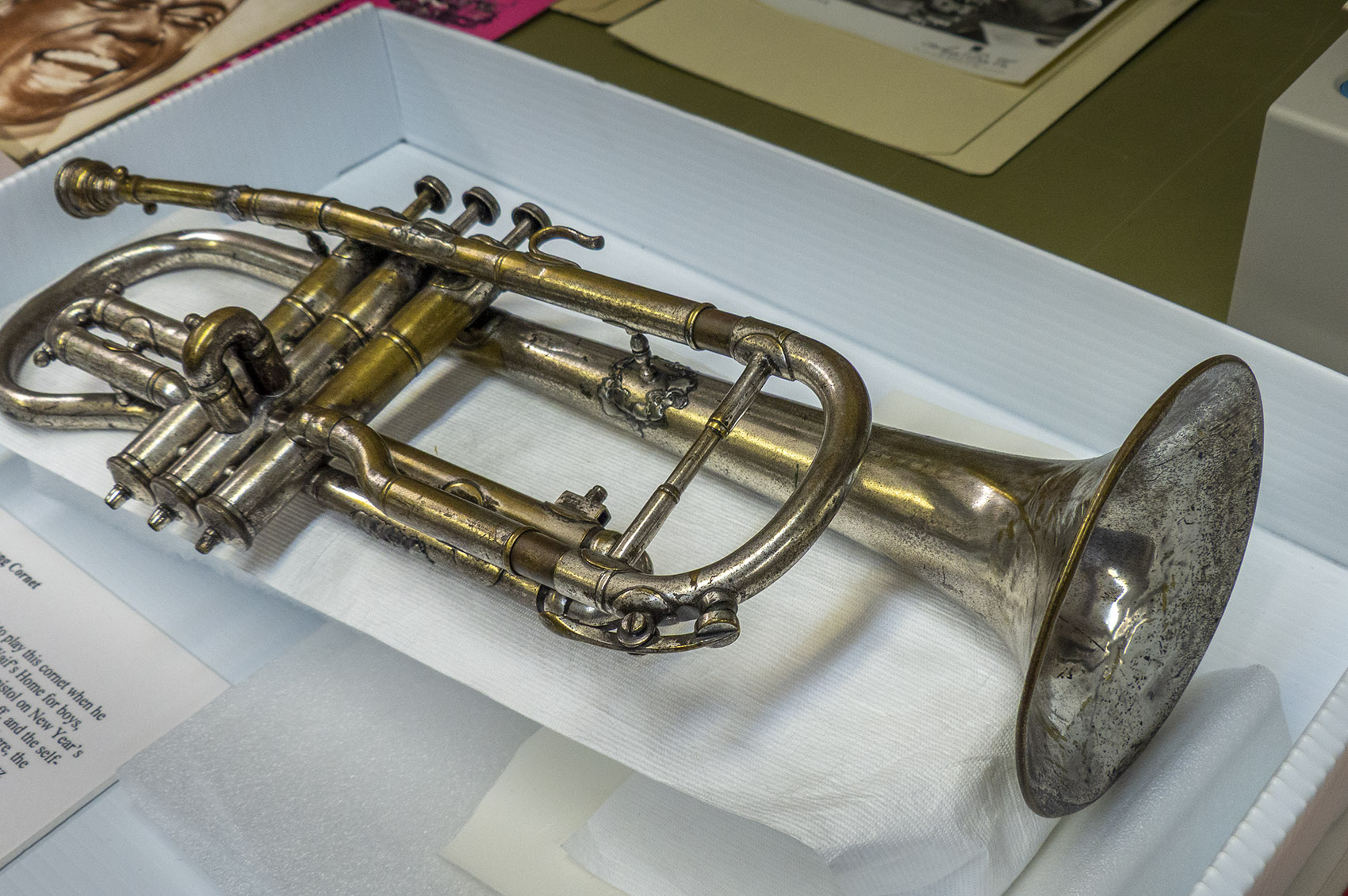 Louis Armstrong's first cornet laying on museum table