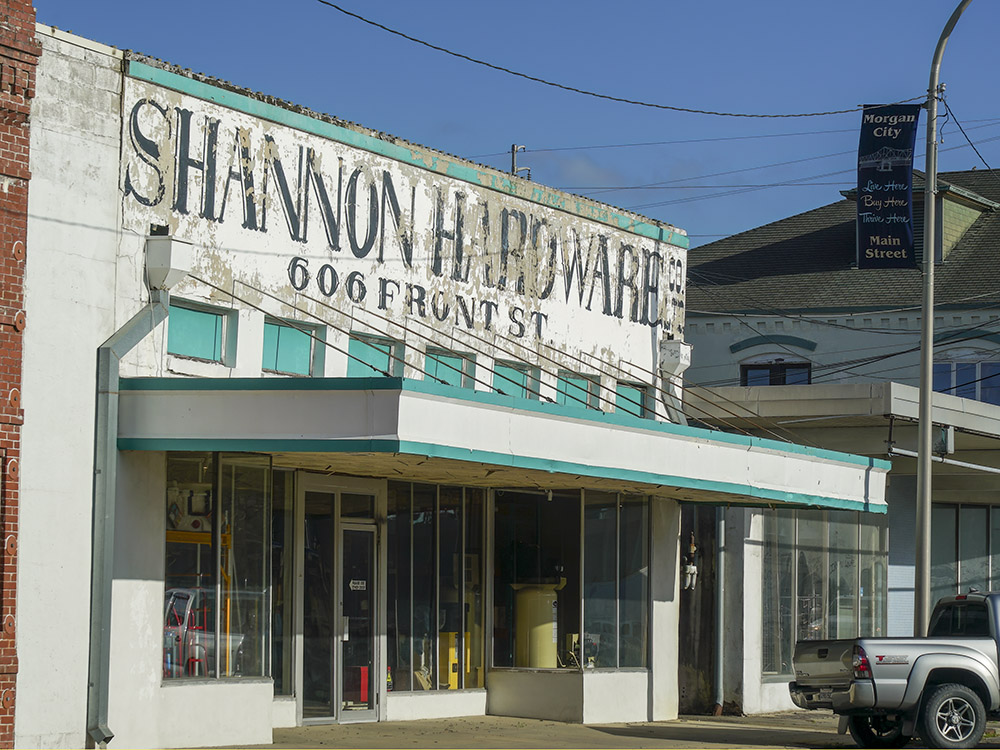 white building with light blue trim and sign Shannon Hardware