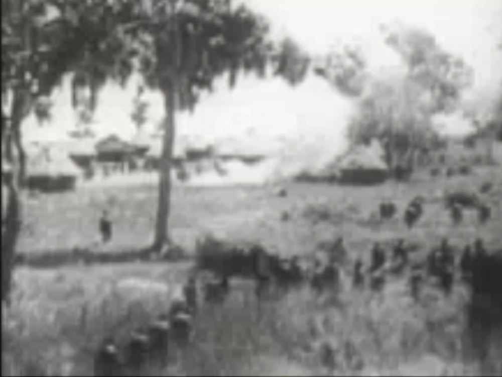 black and white scene from movie showing jungle village