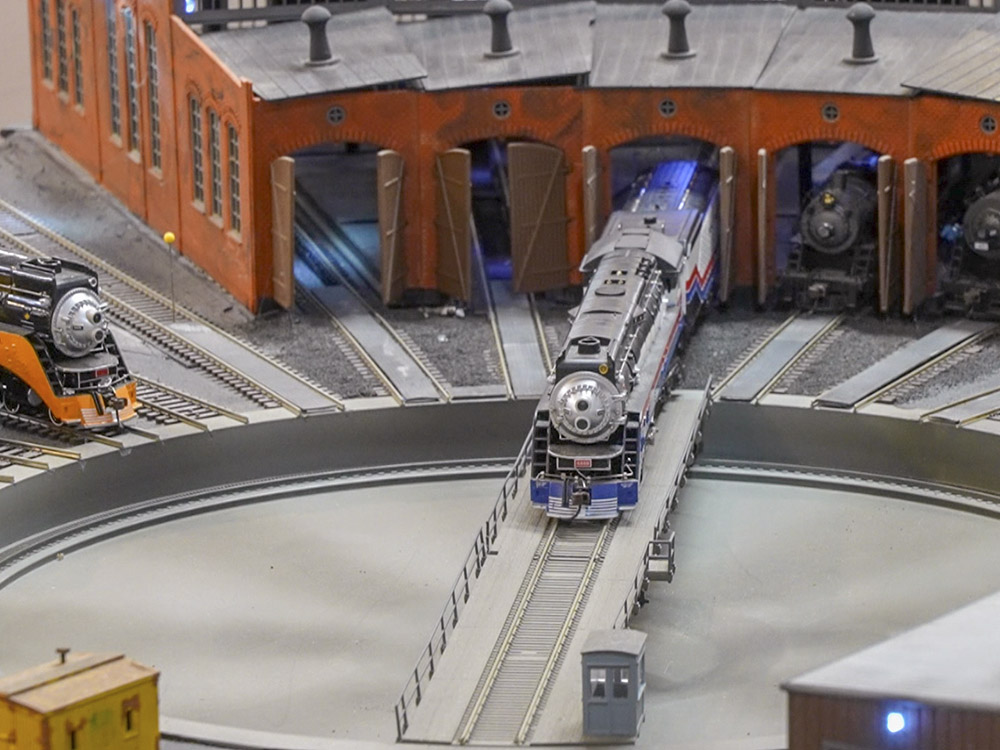 model locomotive moves into roundhouse