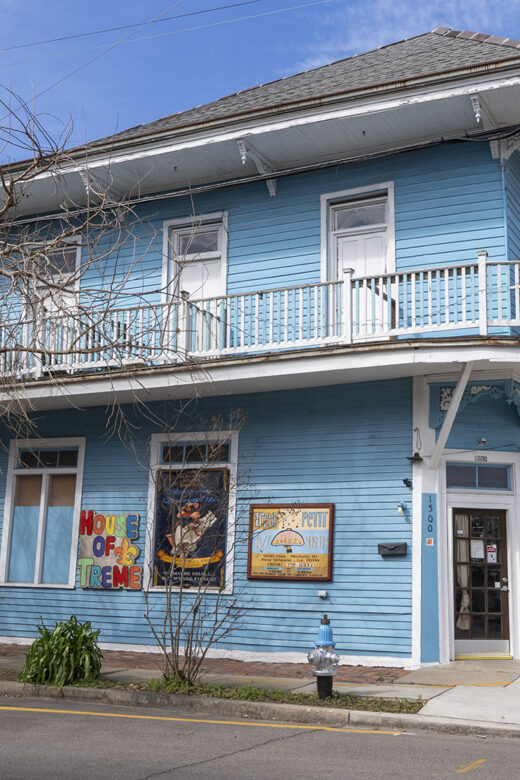 2 story blue wooden building with balcony and sign for Treme Jazz museum