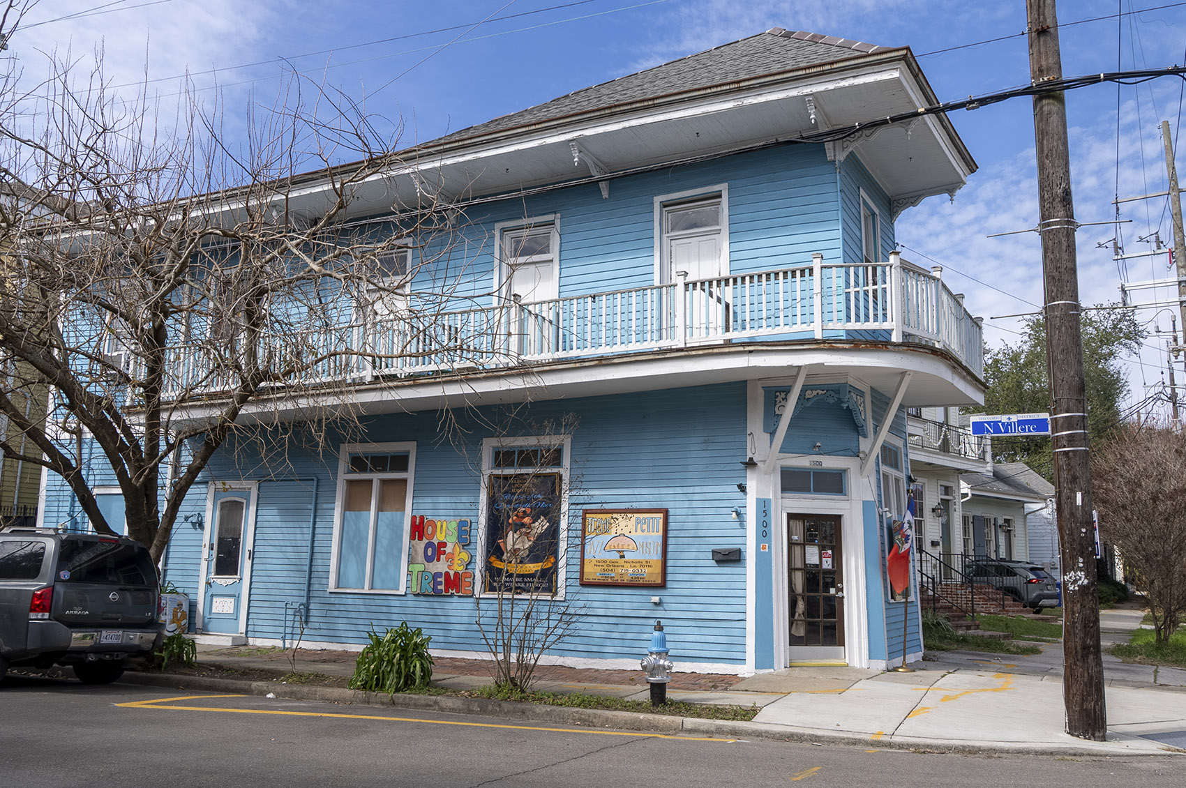 2 story blue wooden building with balcony and sign for Treme Jazz museum