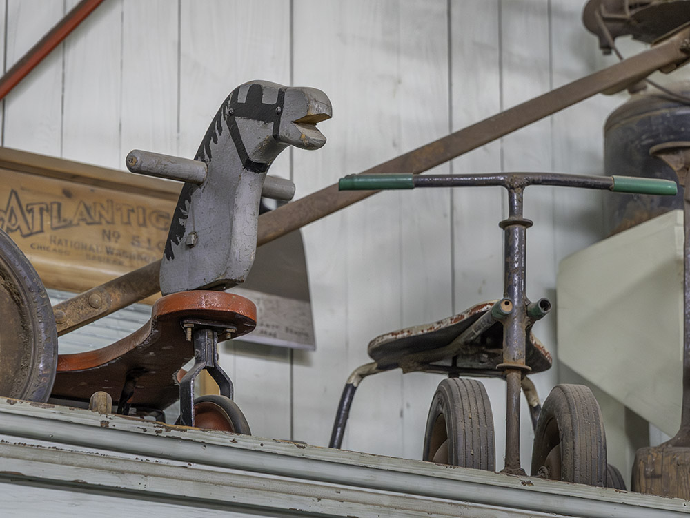 antique scooter with gray horse head and handlebars