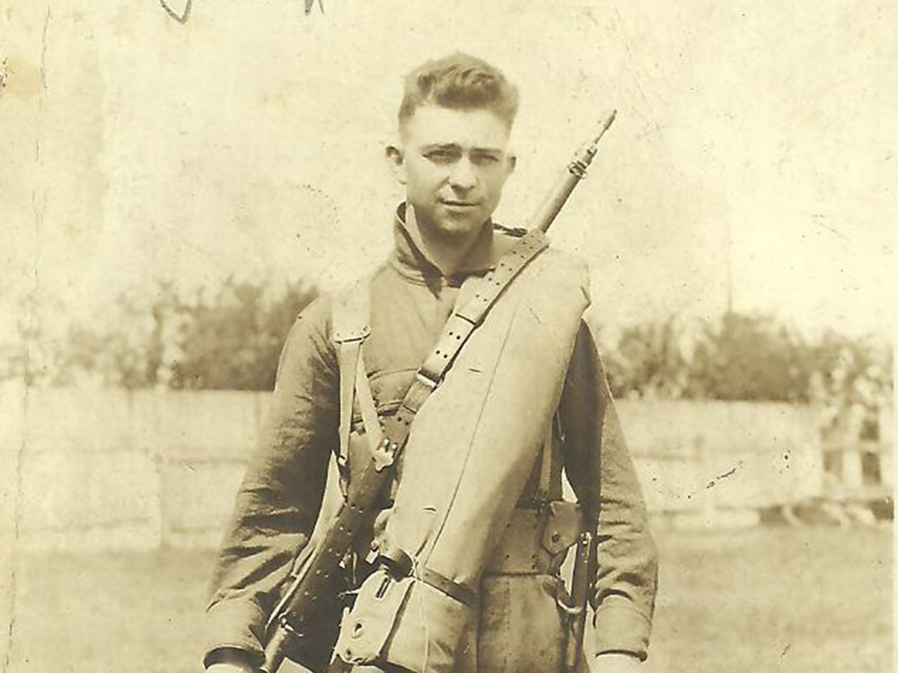 man dressed in world war I army uniform with rifle