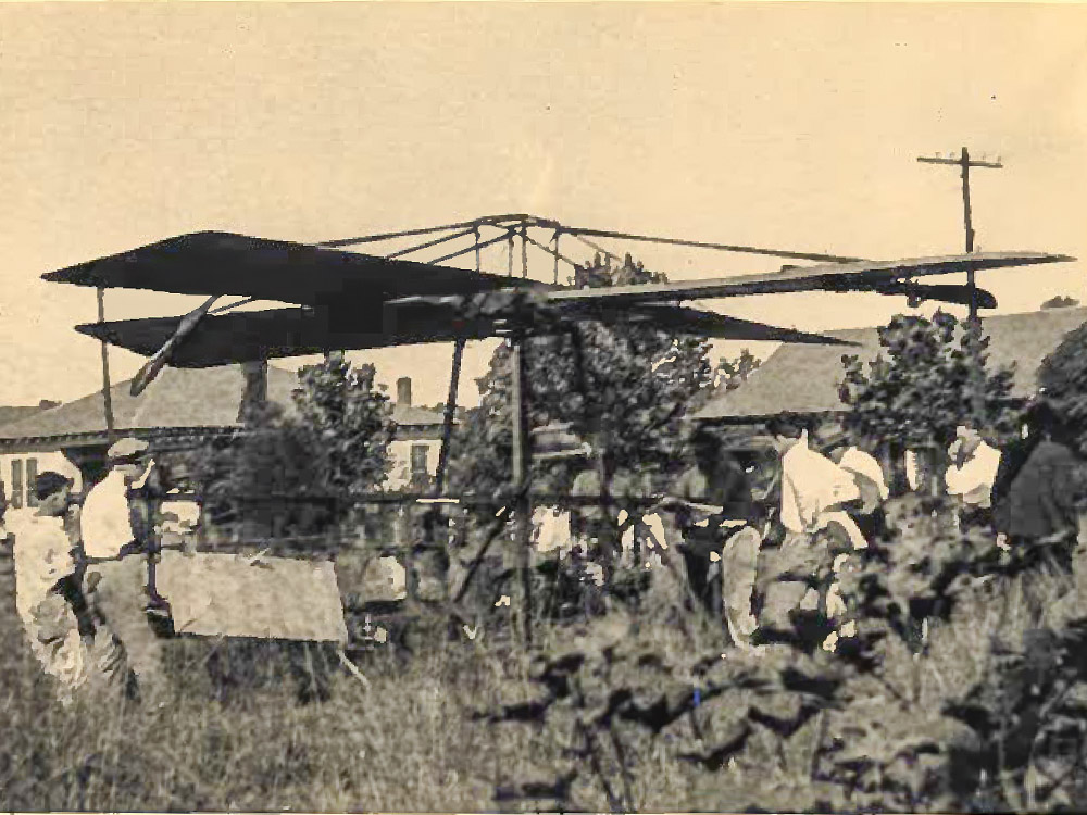 black and white image of a helicopter flying machine