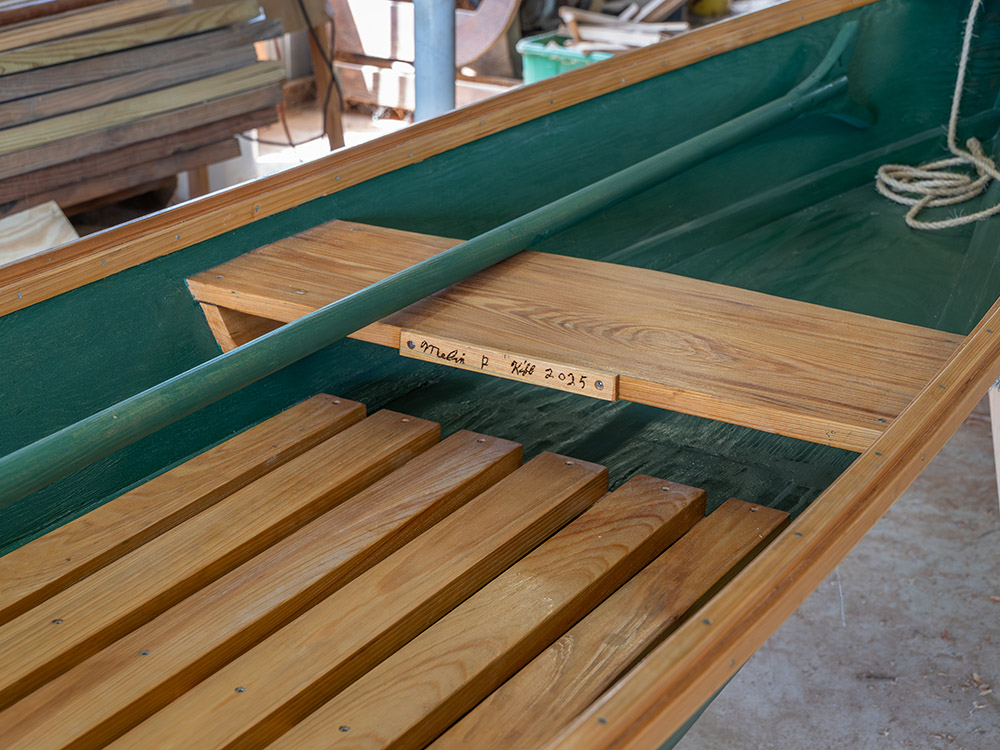 small green and natural wood boat