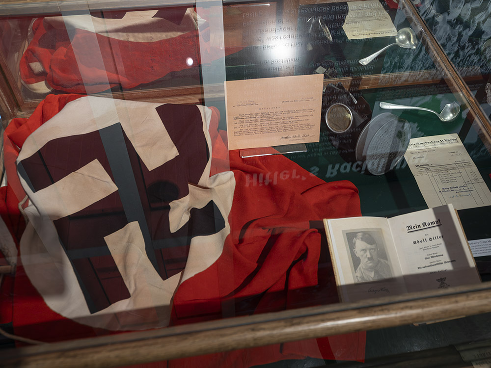 museum display case holding nazi flag and other german artifacts