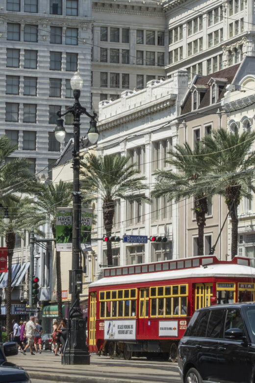 New Orleans historic buildigs and red street car on canal street